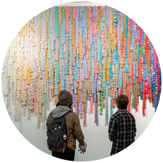 [image] two students admiring an art installation on KSU campus